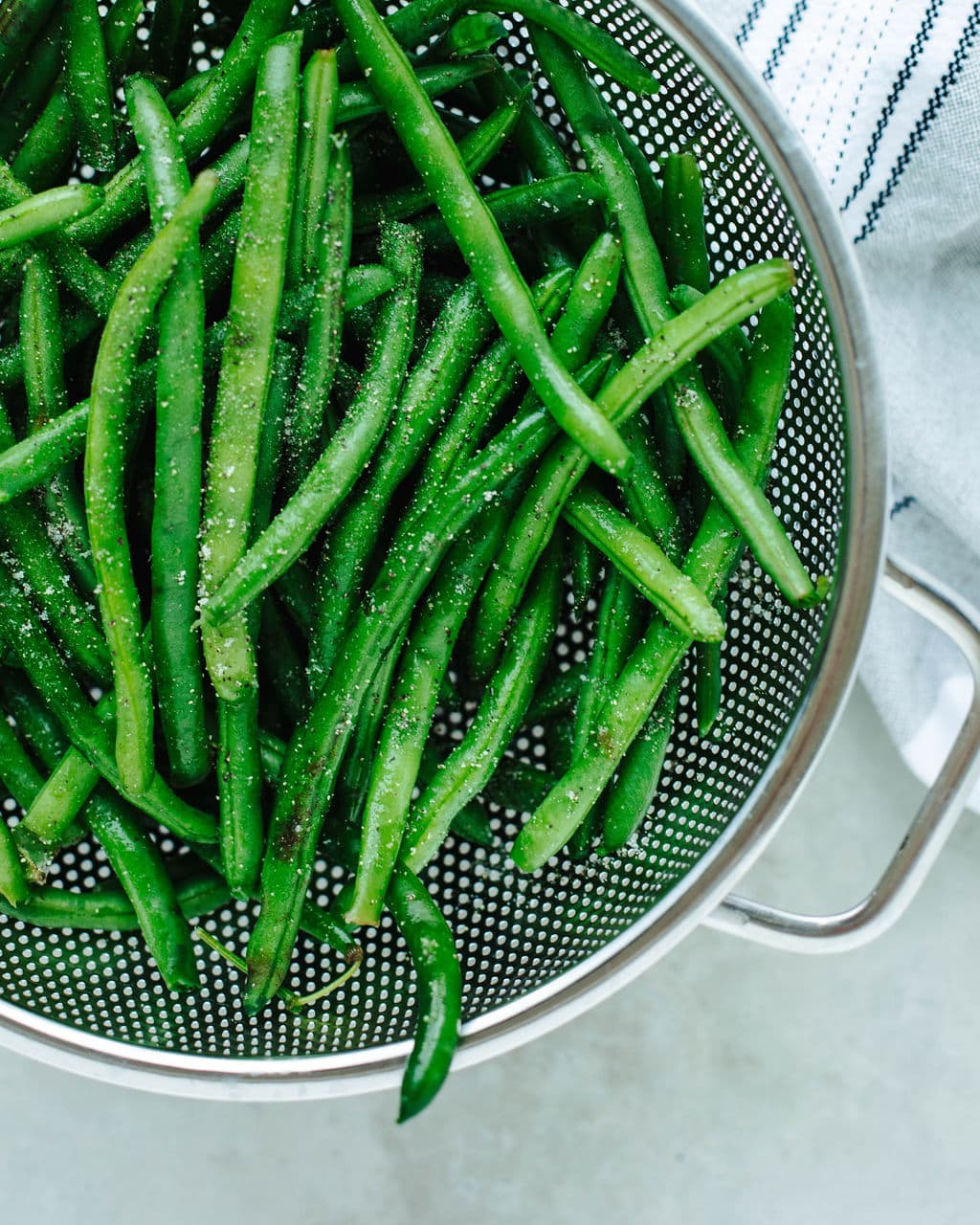 green beans blanched and seasoned in a collander.