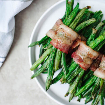 a close up of bacon wrapped green bean bundles