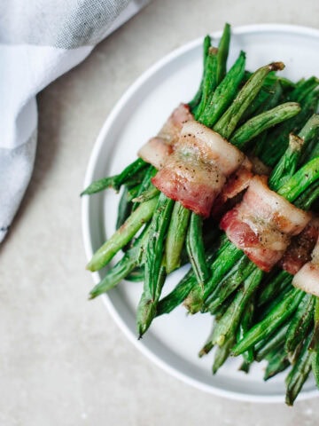 a close up of bacon wrapped green bean bundles