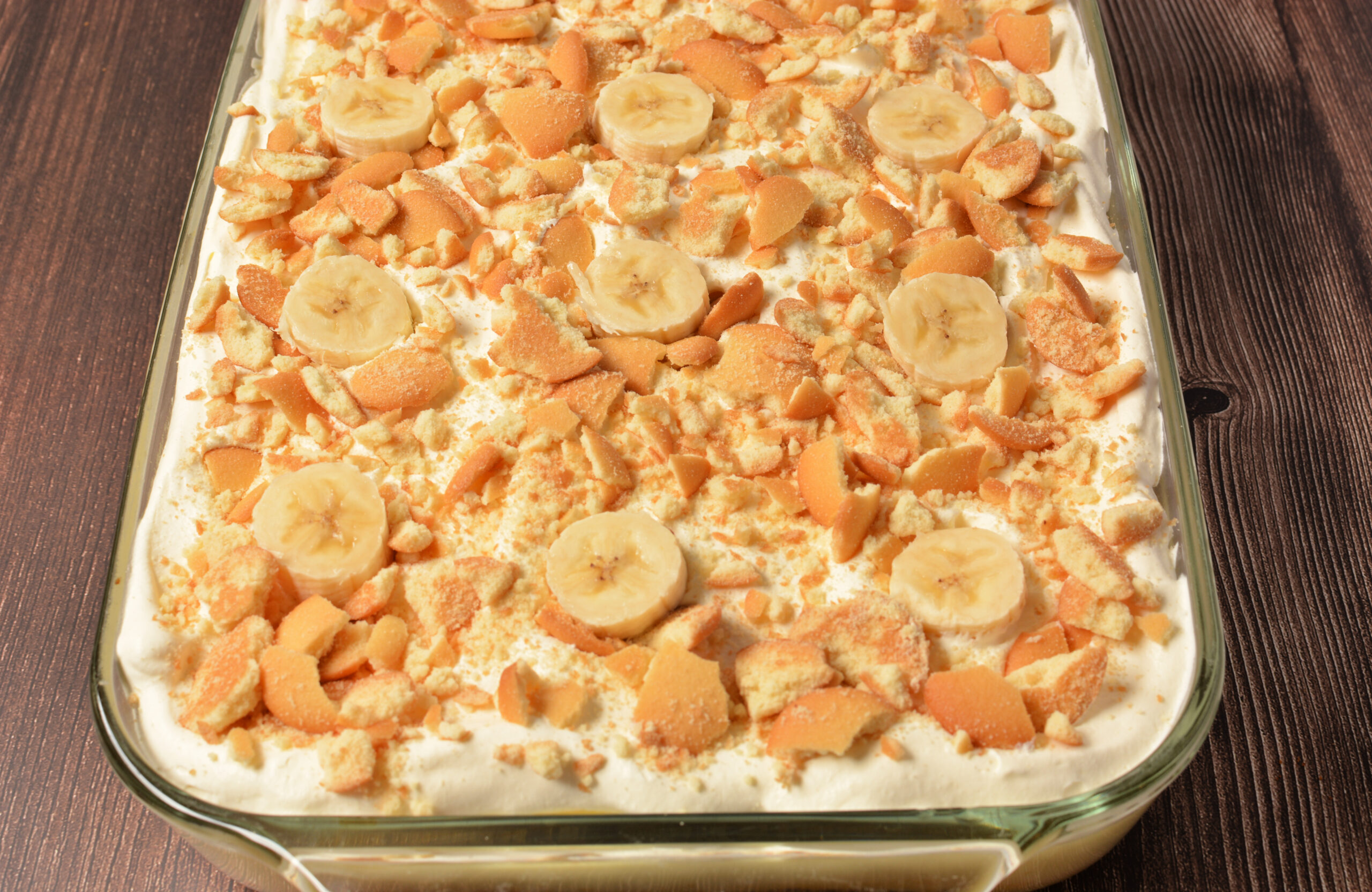 nilla wafers over whipped cream, yellow cake, and pudding