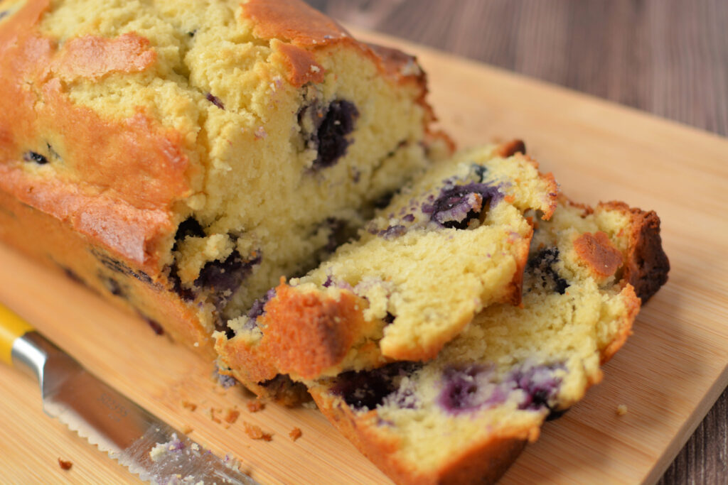 blueberry muffin bread sliced on a cutting board