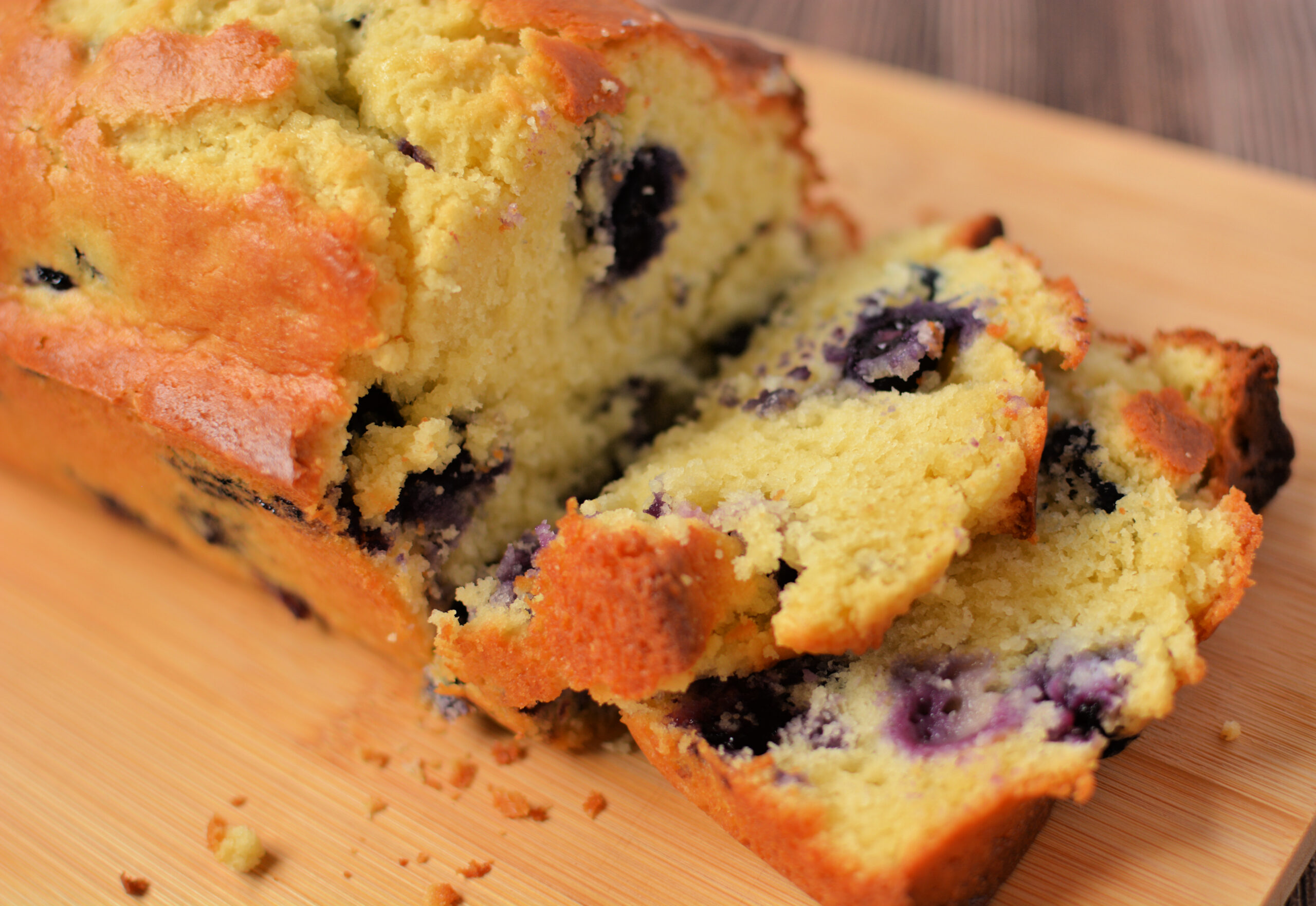 sliced blueberry muffin bread on a cutting board.