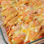 cheesy mexican stuffed shells in a baking pan