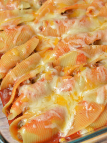cheesy mexican stuffed shells in a baking pan