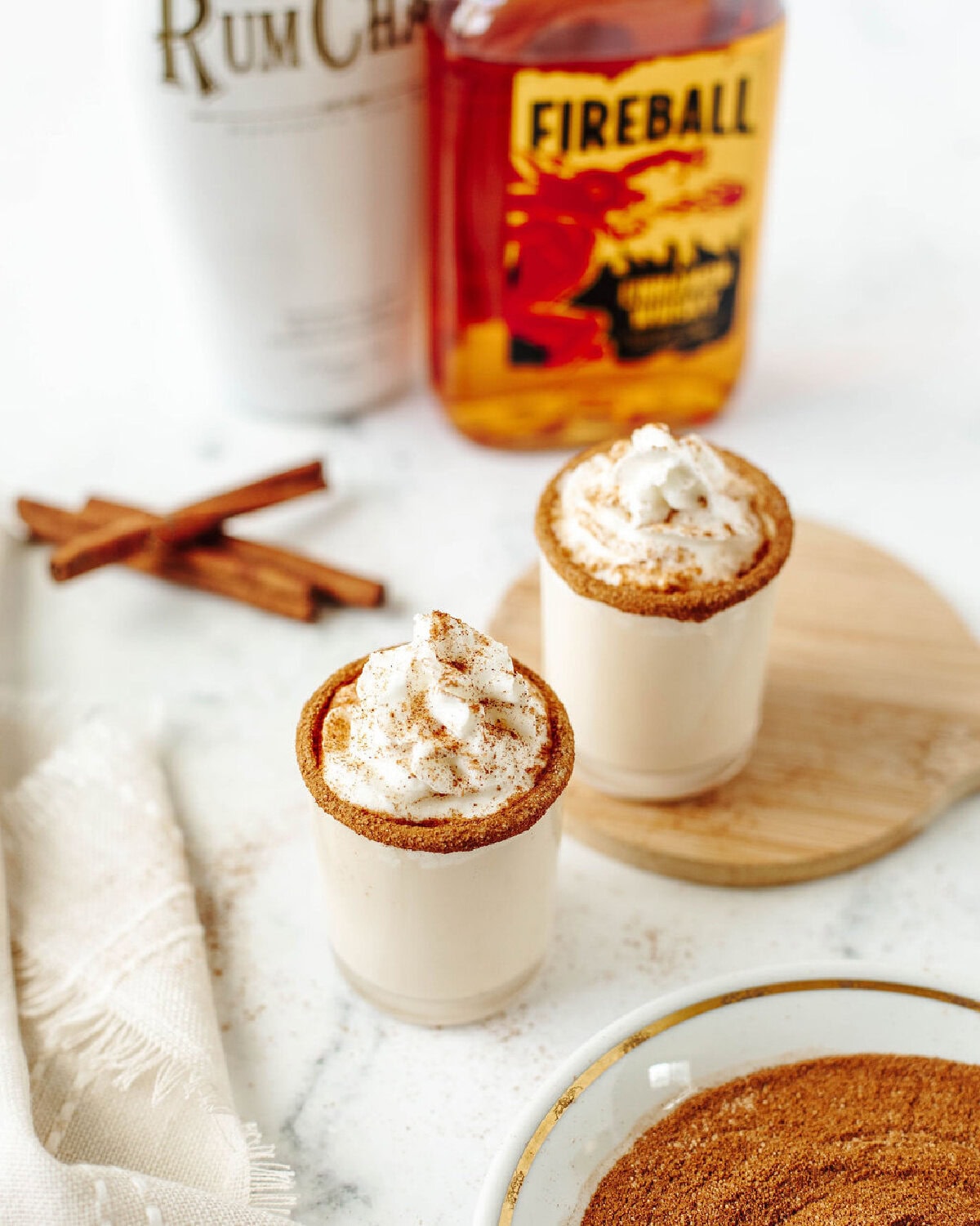 cinnamon toast crunch shots with whipped cream and cinnamon sugar rim ready to serve.