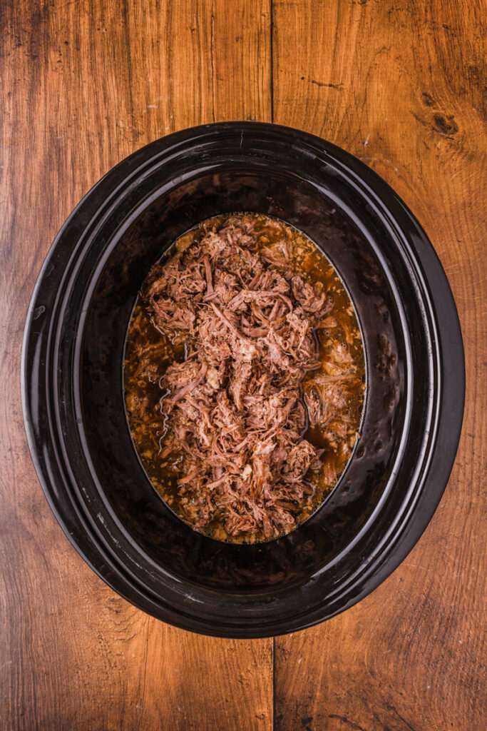 shredded roast beef in a slow cooker