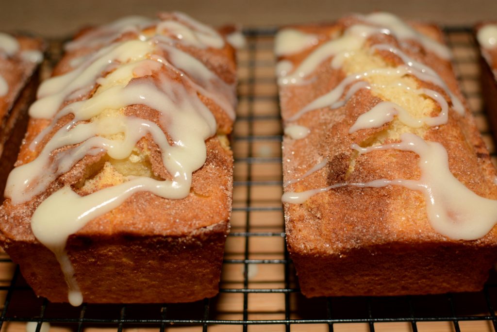 fluffy quick bread with cinnamon sugar throughout and a cream cheese frosting on top