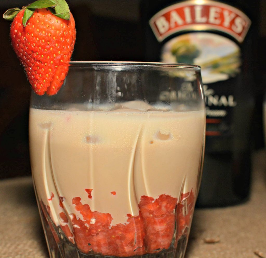 Creamy Baileys Irish Cream Liquor mixed with sweet blended strawberries and garnished with a sliced strawberry