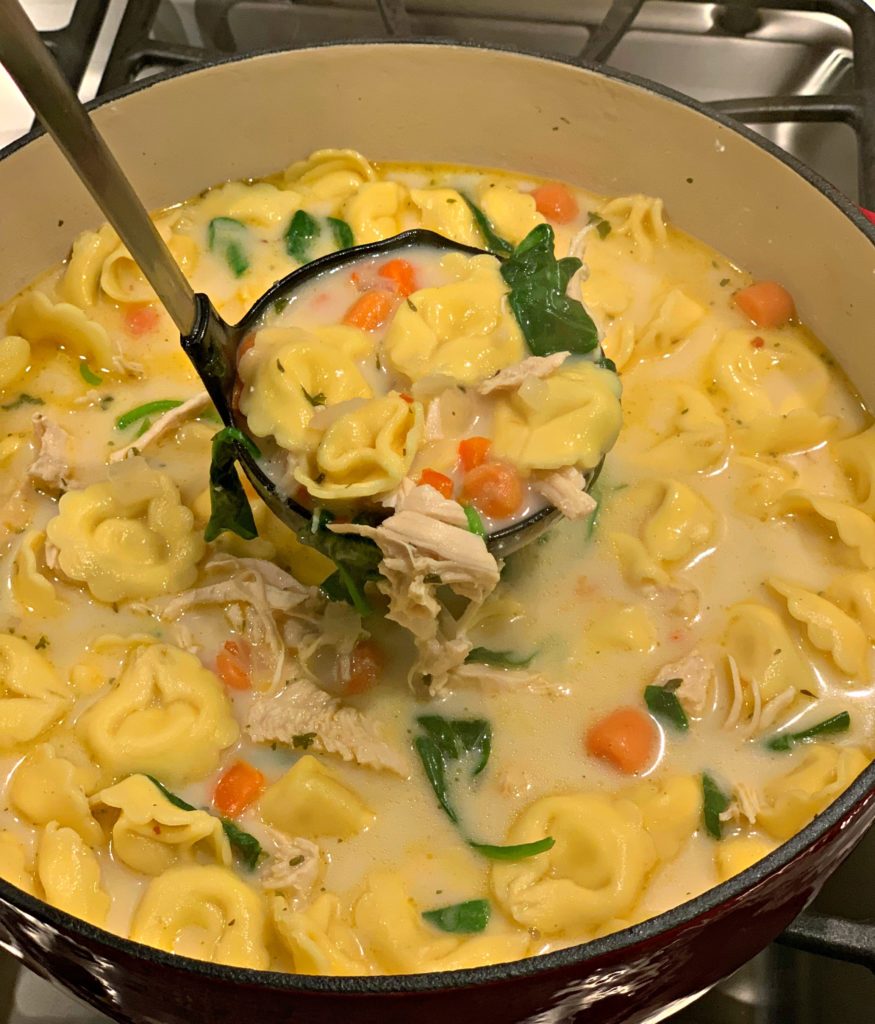 tender tortellini with chicken and vegetables in a creamy broth