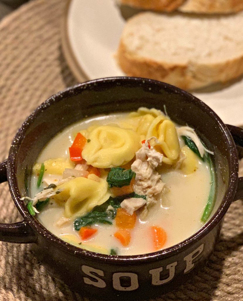 a bowl of tortellini soup