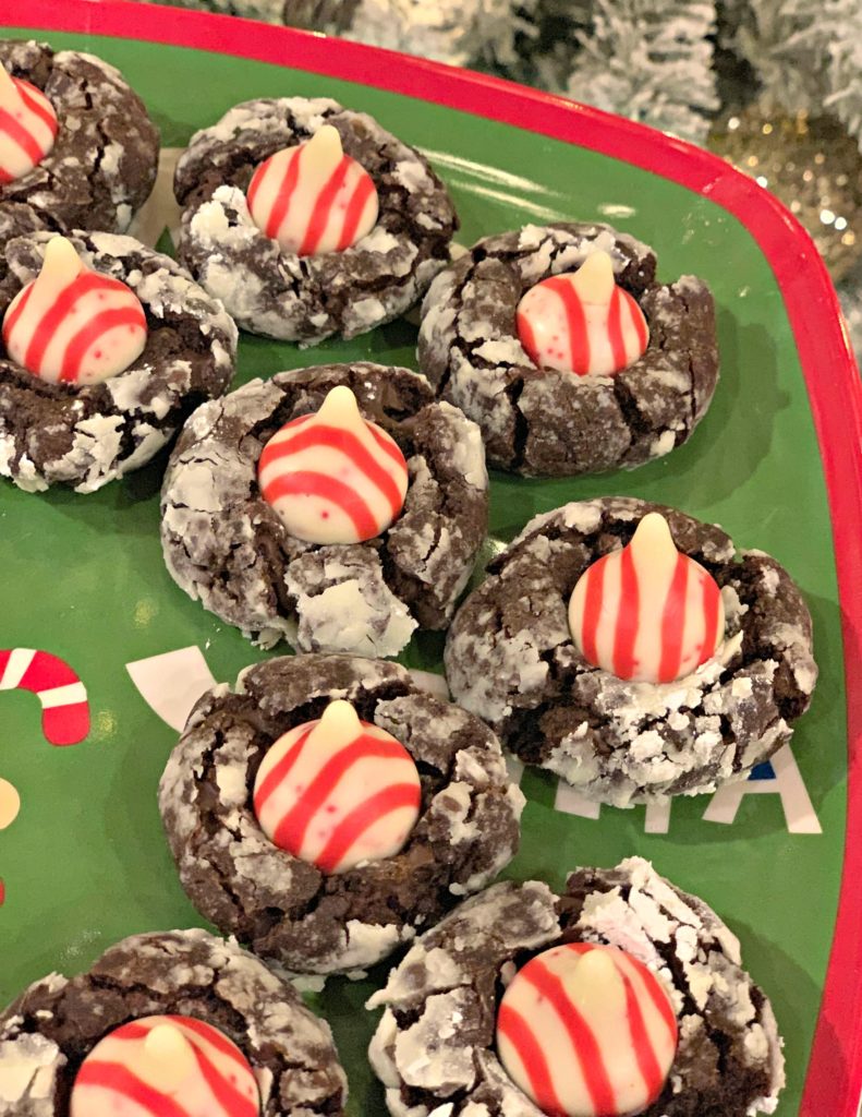 festive chocolate crinkle cookies with an added candy cane kiss in the center