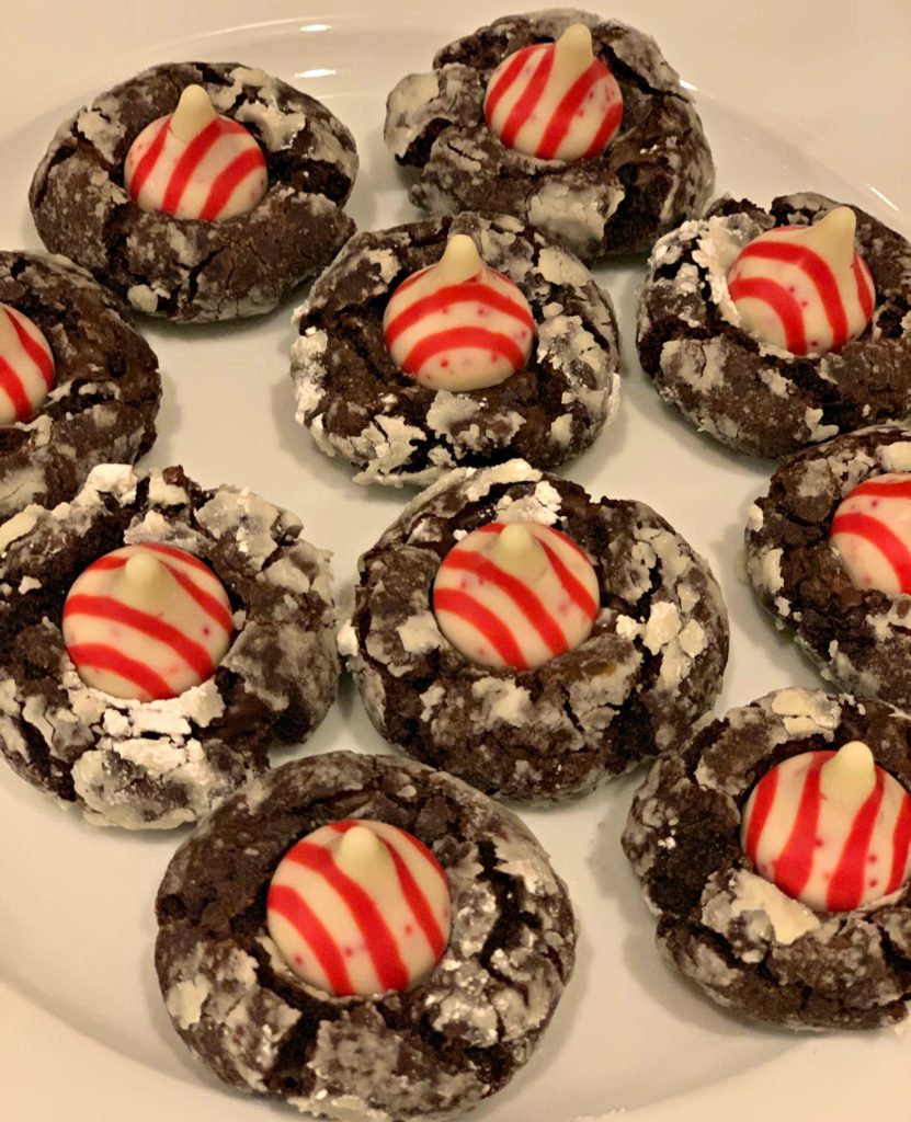 chocolate cookies with a candy cane kiss in the center
