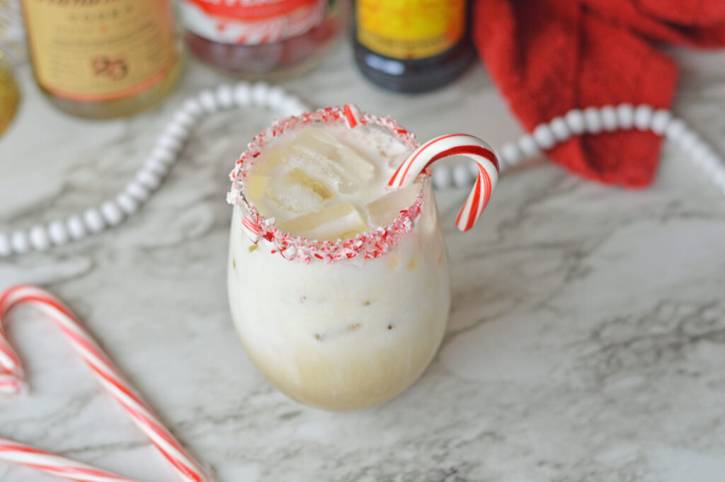 a Peppermint White Russian glass rimmed with candy canes.