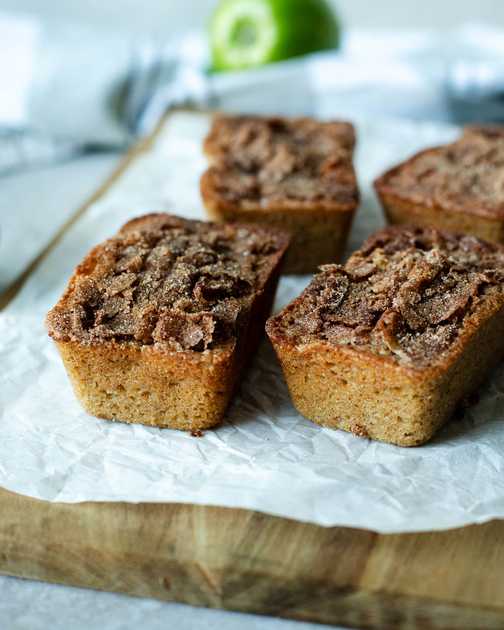 mini loaves of snickerdoodle apple bread on a cutting board.