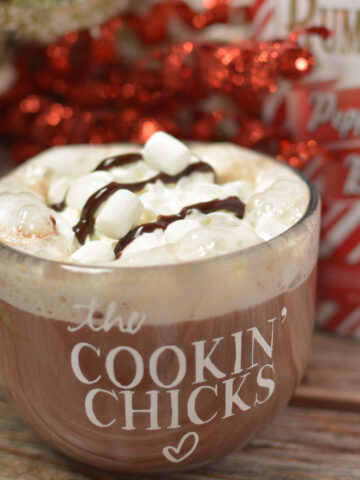 creamy hot chocolate with whipped cream and chocolate on top.