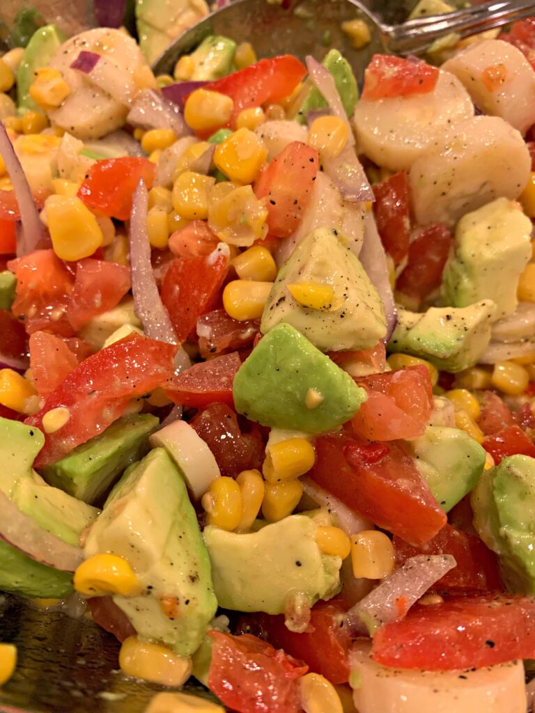 hearts of palm salad with tomatoes, corn, onion, avocado, and more