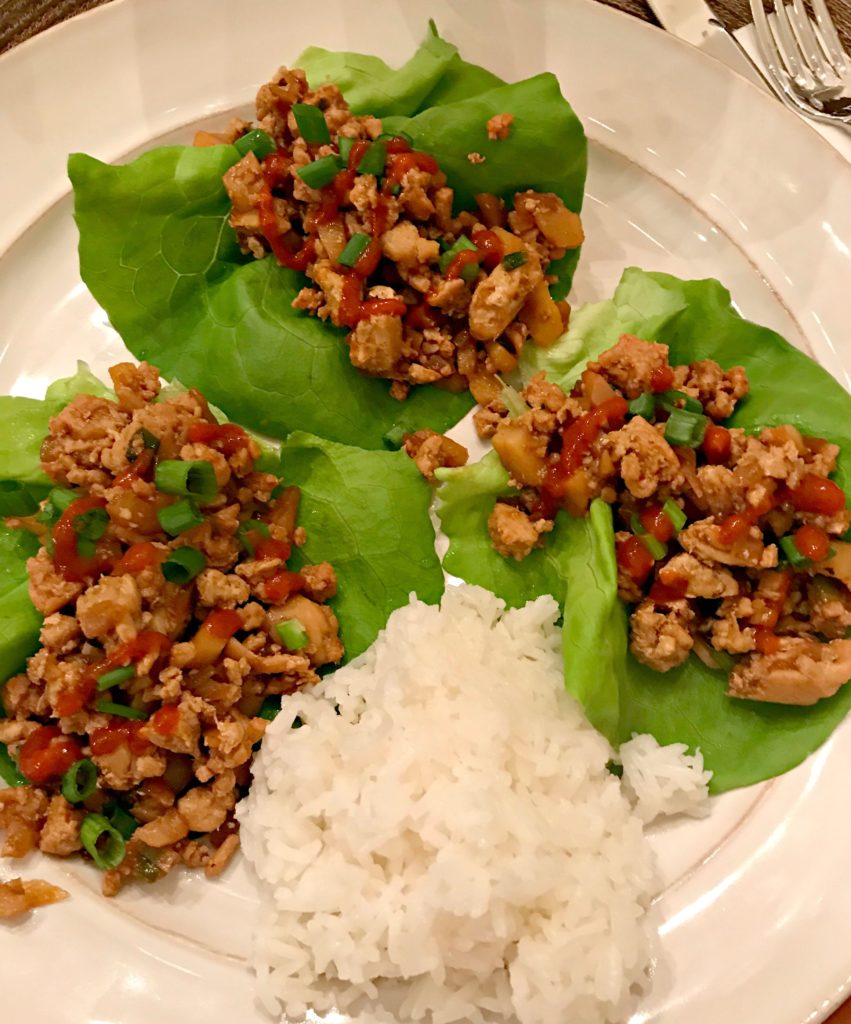 cooked chicken in an asian sauce served in lettuce wraps