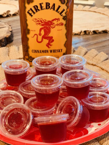 fireball jello shots set up in plastic cups ready to be enjoyed