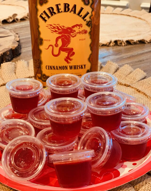fireball jello shots set up in plastic cups ready to be enjoyed