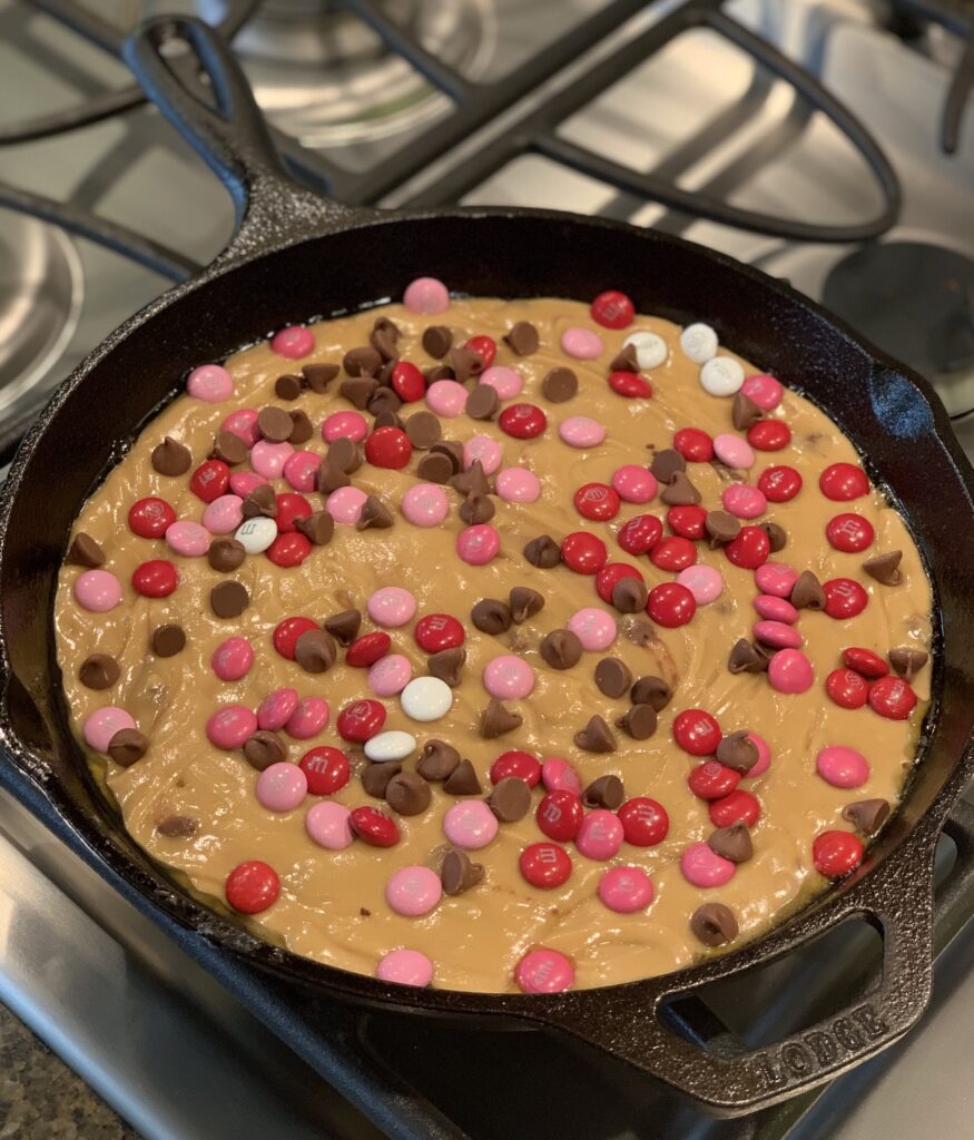 chocolate chips and m & m's combined into a skillet cookie