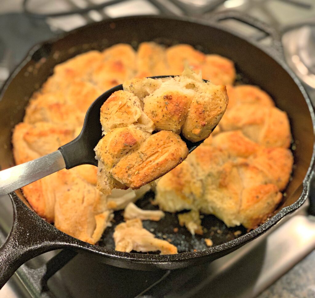 biscuits seasoned with garlic and parmesan, cooked in a cast iron skillet
