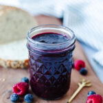 a glass mason jar with homemade jelly insdie.
