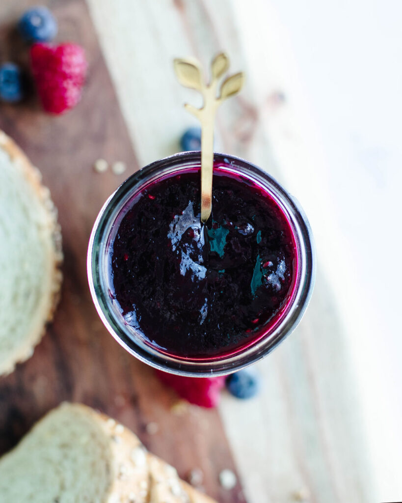 a mixed berry jam made in the pressure cooker and poured into a glass mason jar.
