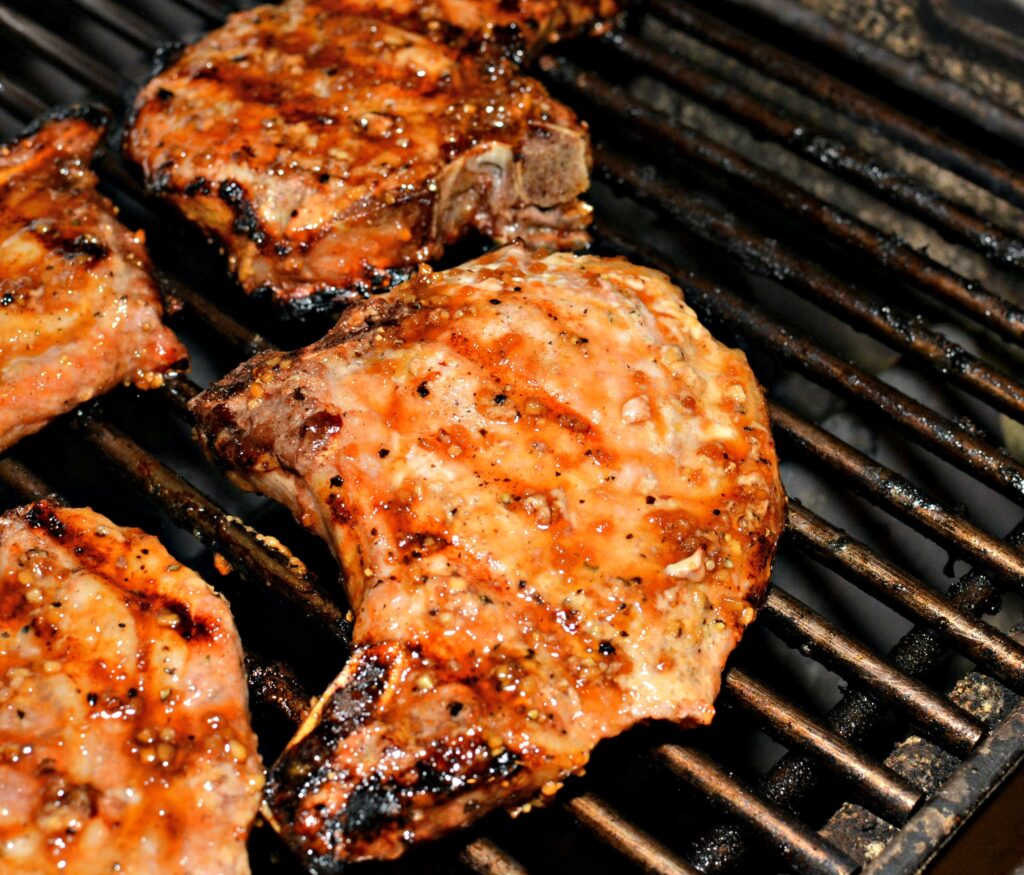 Perfectly grilled pork chops on the grates