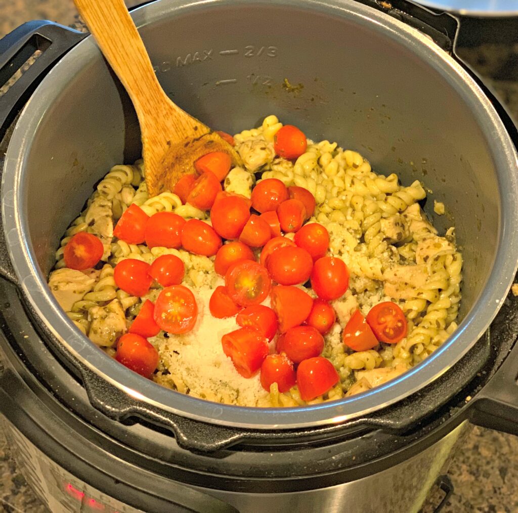 tender noodles, cherry tomatoes, chicken, and a pesto sauce combined