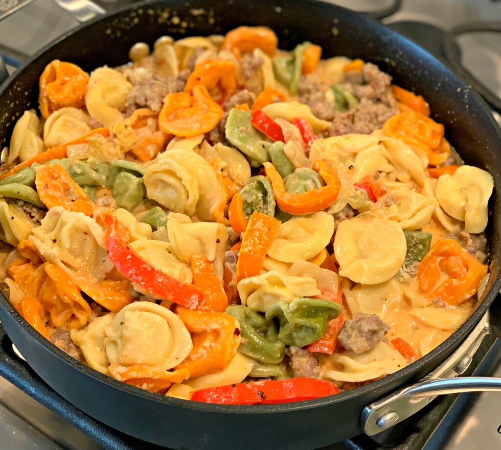 tortellini, Italian sausage, and a cream sauce cooked in a skillet