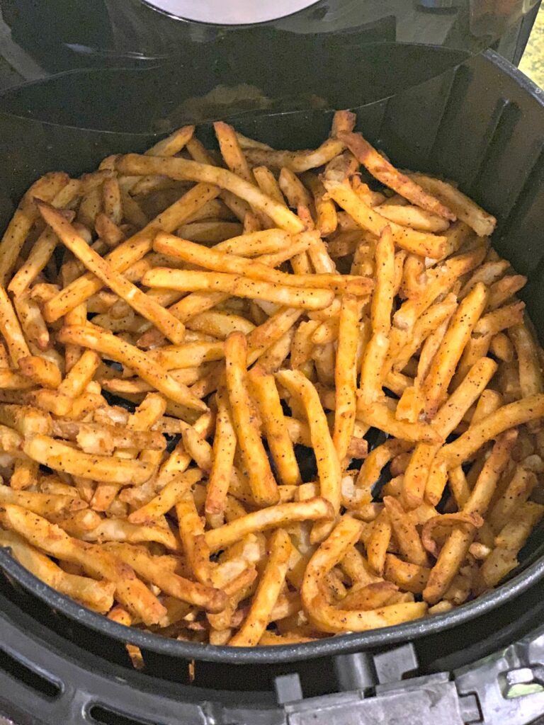 a basket of frozen french fries cooked in the air fryer