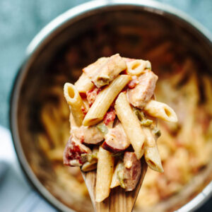 tender creamy pasta on a wooden spoon from the instant pot.