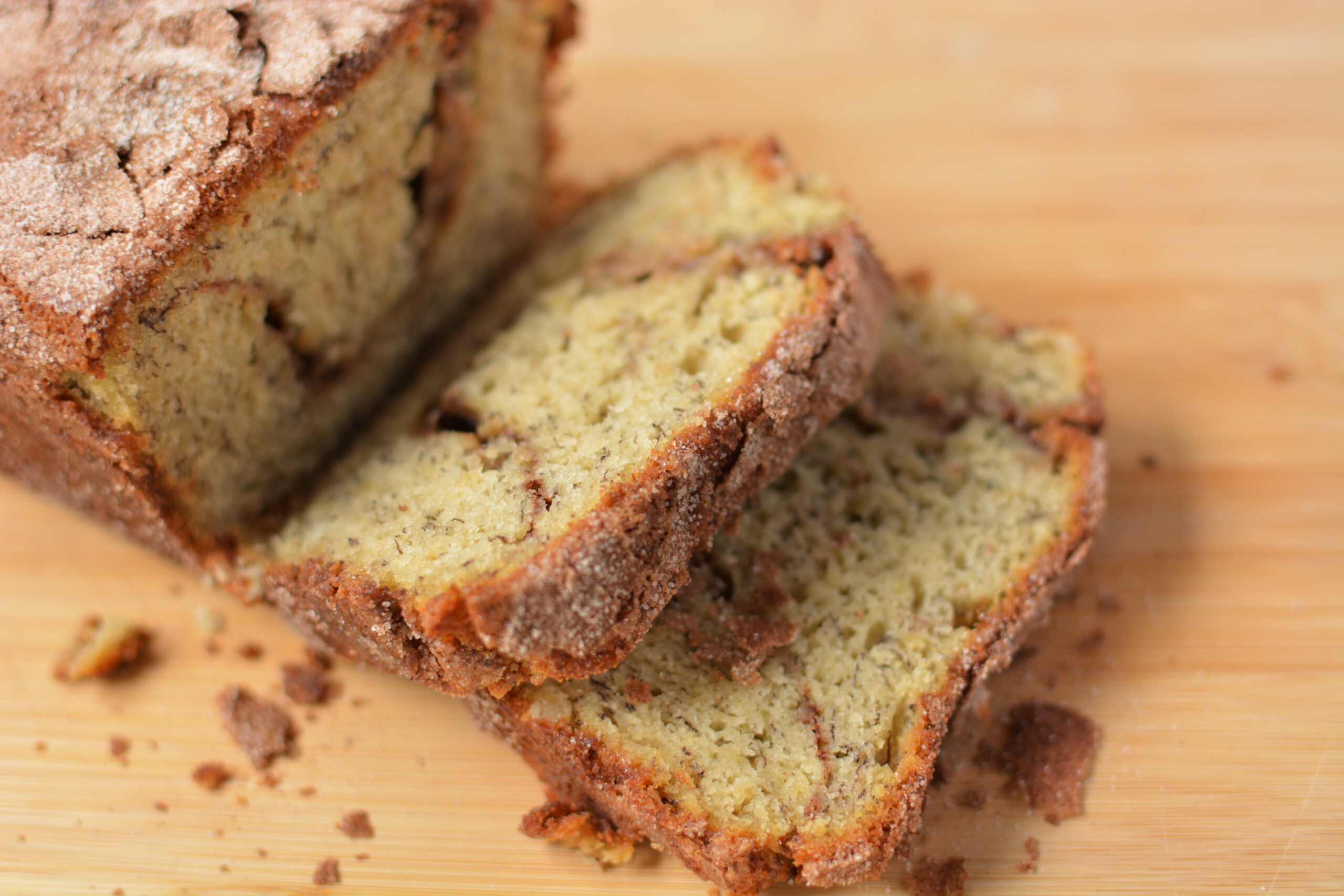 slices of snickerdoodle banana bread on a wood board.