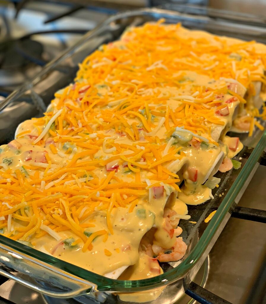 Tasty Shrimp Enchiladas covered in cheddar cheese!