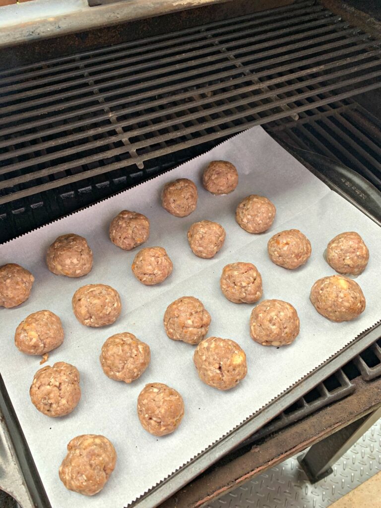 meatballs being cooked on the smoker
