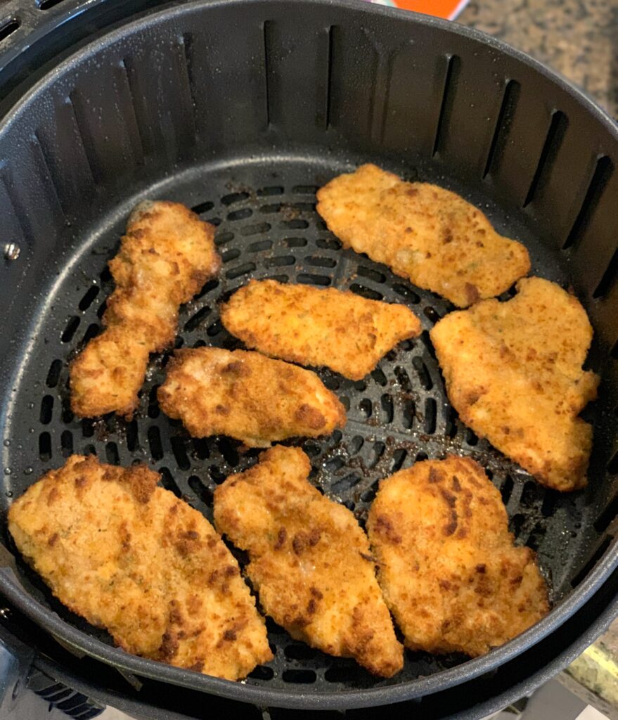 crispy chicken tenders in an air fryer basket