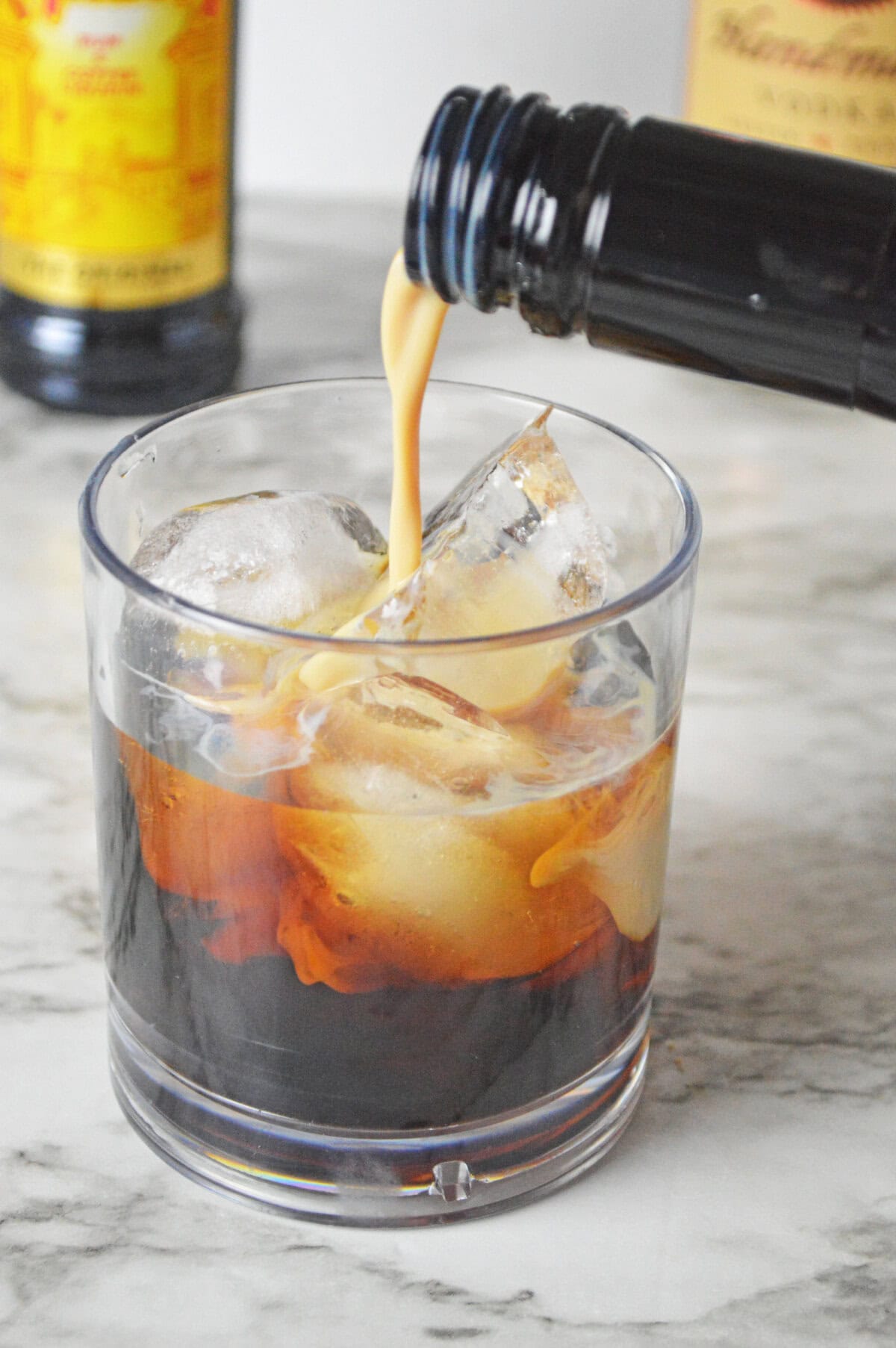 Bailey's Irish cream floated on top of vodka and Kahlua in a glass.