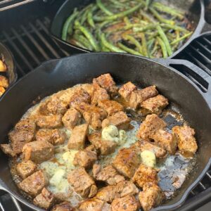 tender garlic butter steak bites cooked on the grill