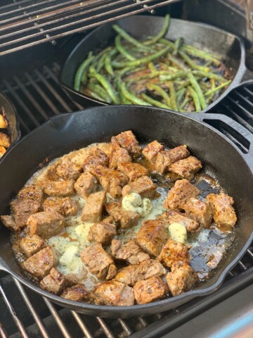 tender garlic butter steak bites cooked on the grill