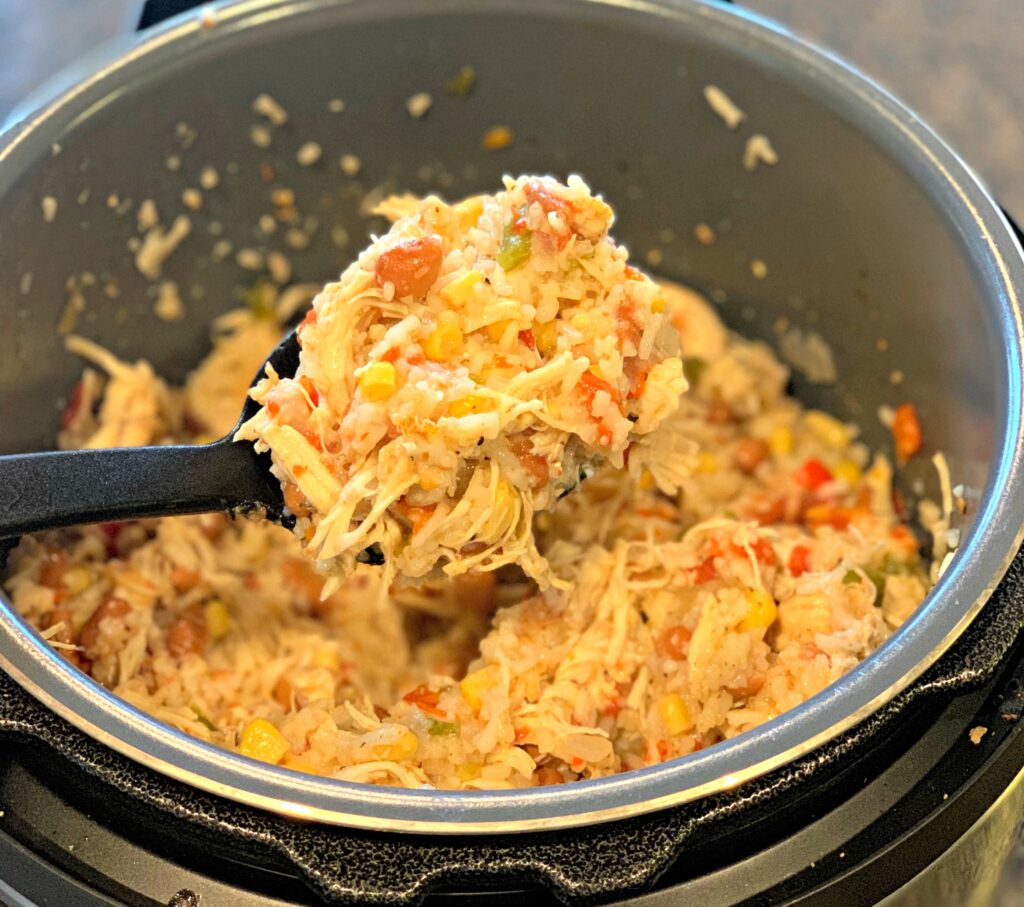 rice, chicken, beans, and corn cooked in the instant pot and served in bowls with toppings