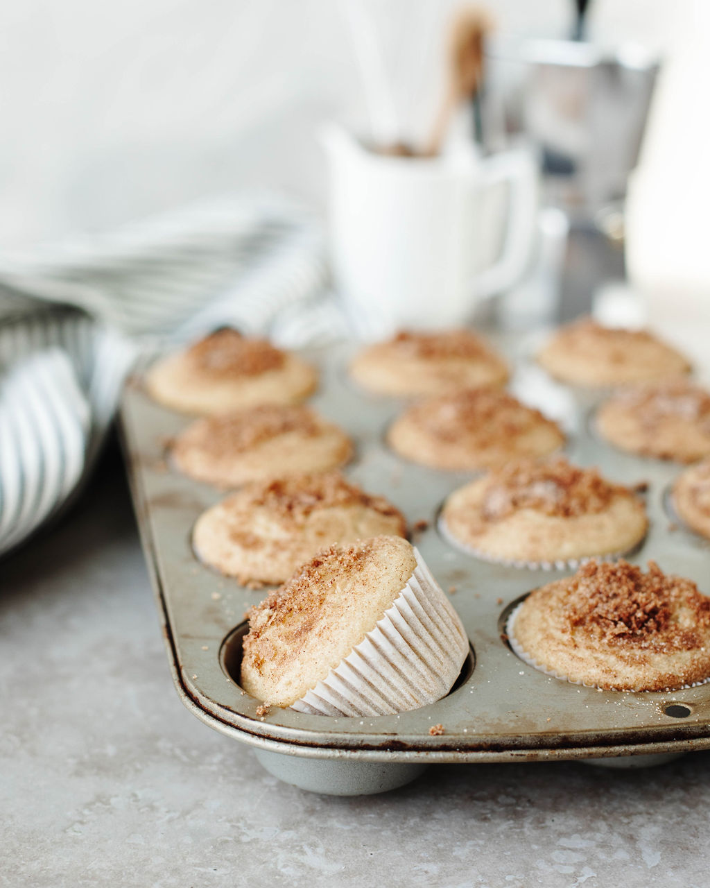 Sweet breakfast muffins with cinnamon sugar topping in muffin tin.