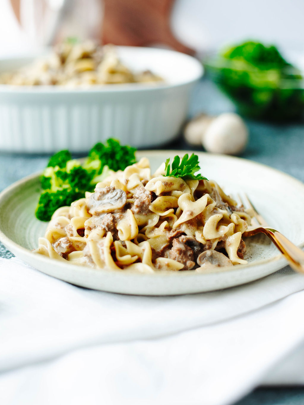 a serving of instant pot beef stroganoff on a white dinner plate.