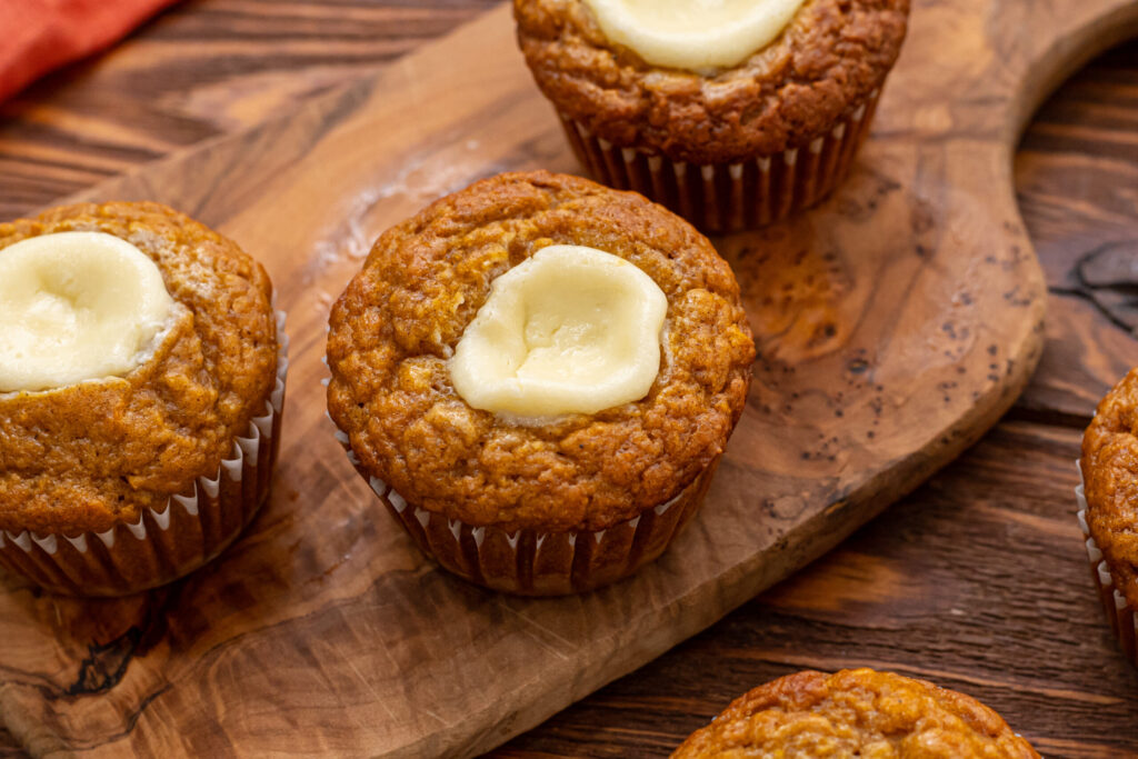 perfectly spiced pumpkin muffins with a creamy filling