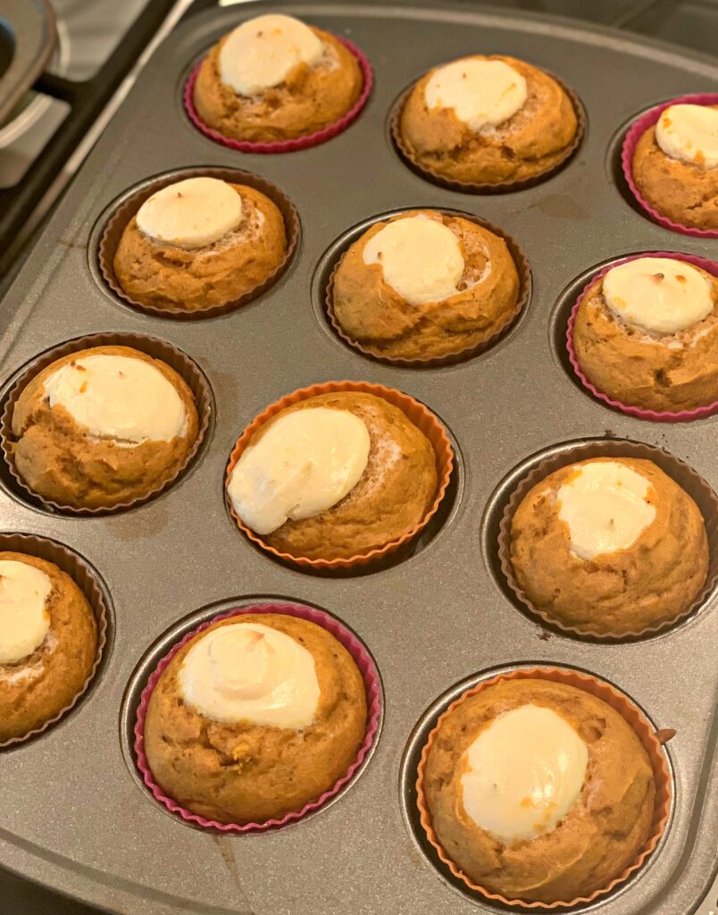 Pumpkin Cream Cheese Muffins in a baking pan from the oven.