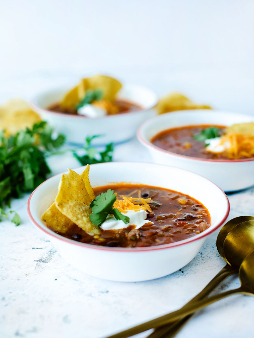 instant pot taco soup in a white bowl with toppings.