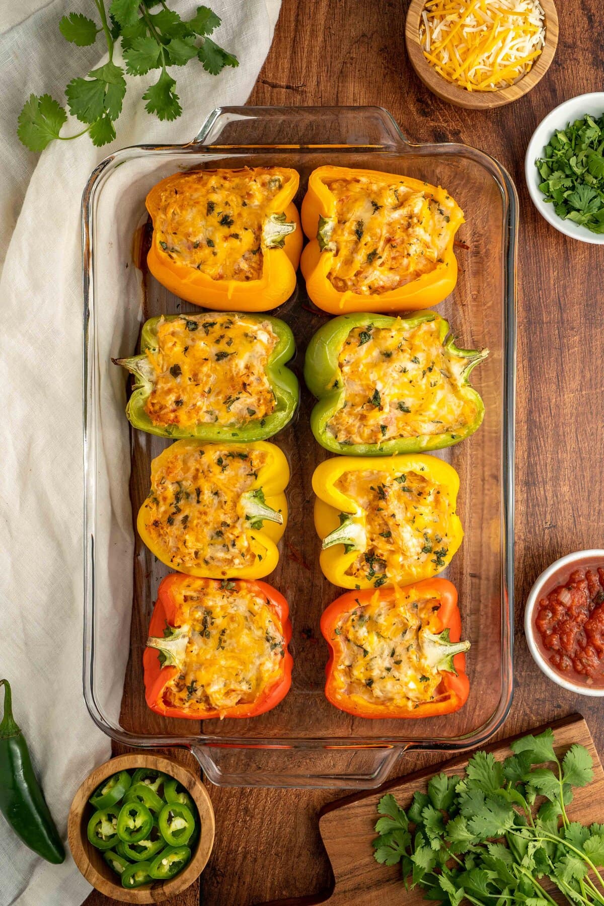 sliced peppers lined up in a baking pan ready for the oven