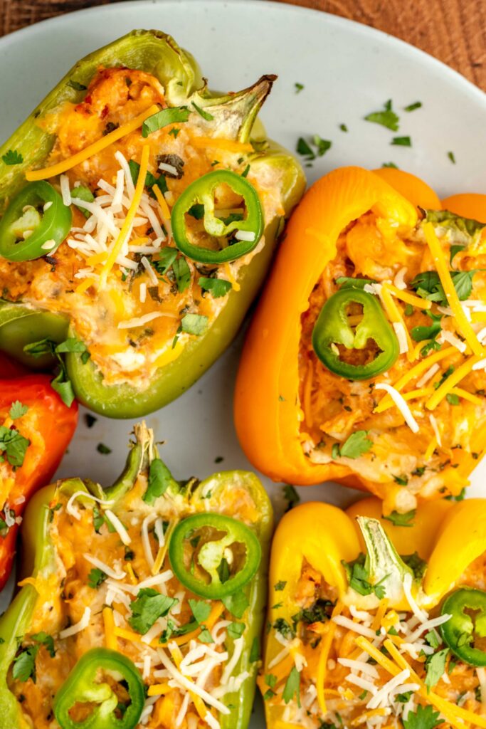 cheese and jalapenos on top of chicken stuffed bell peppers.