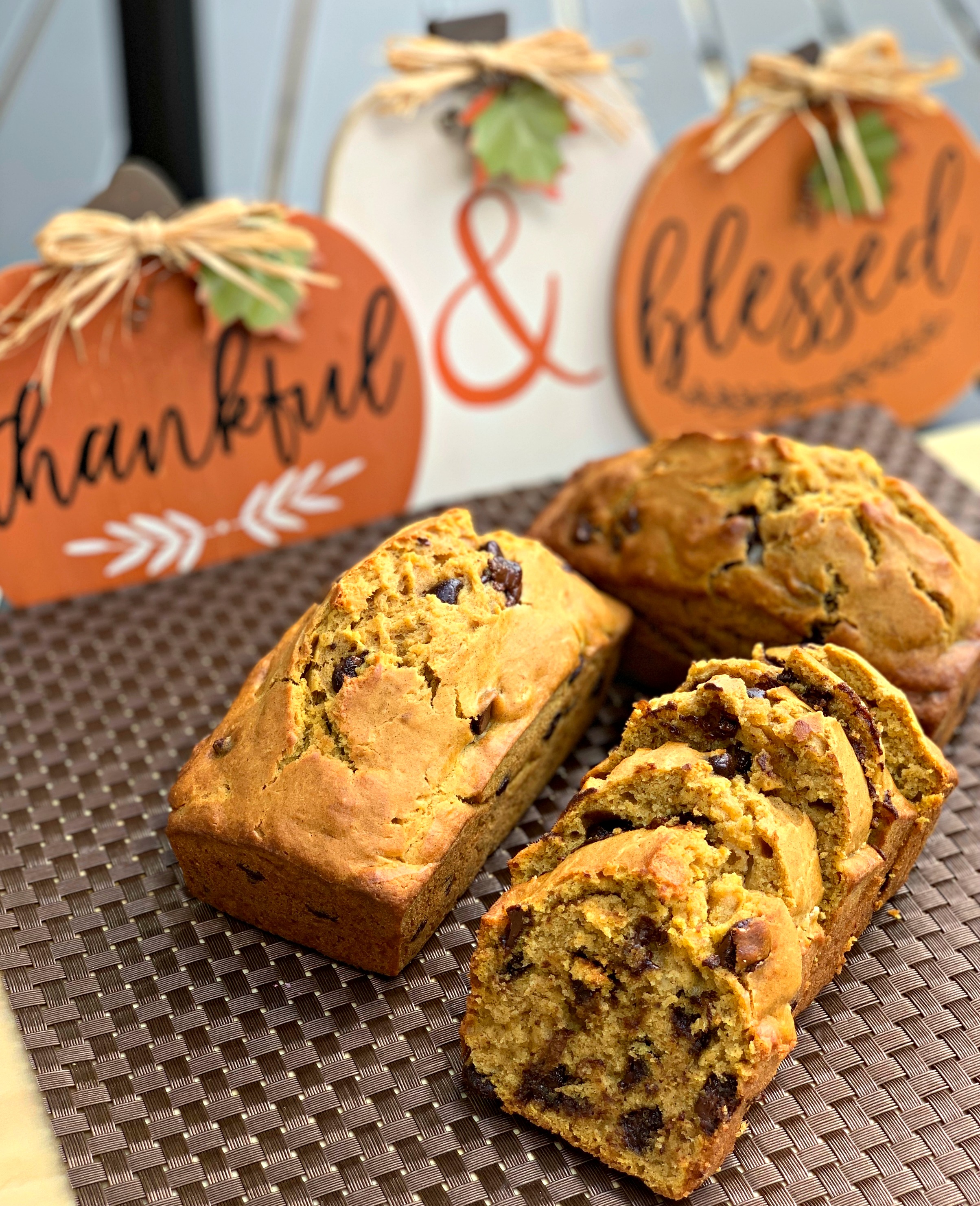 pumpkin banana bread sliced on a brown placemat.