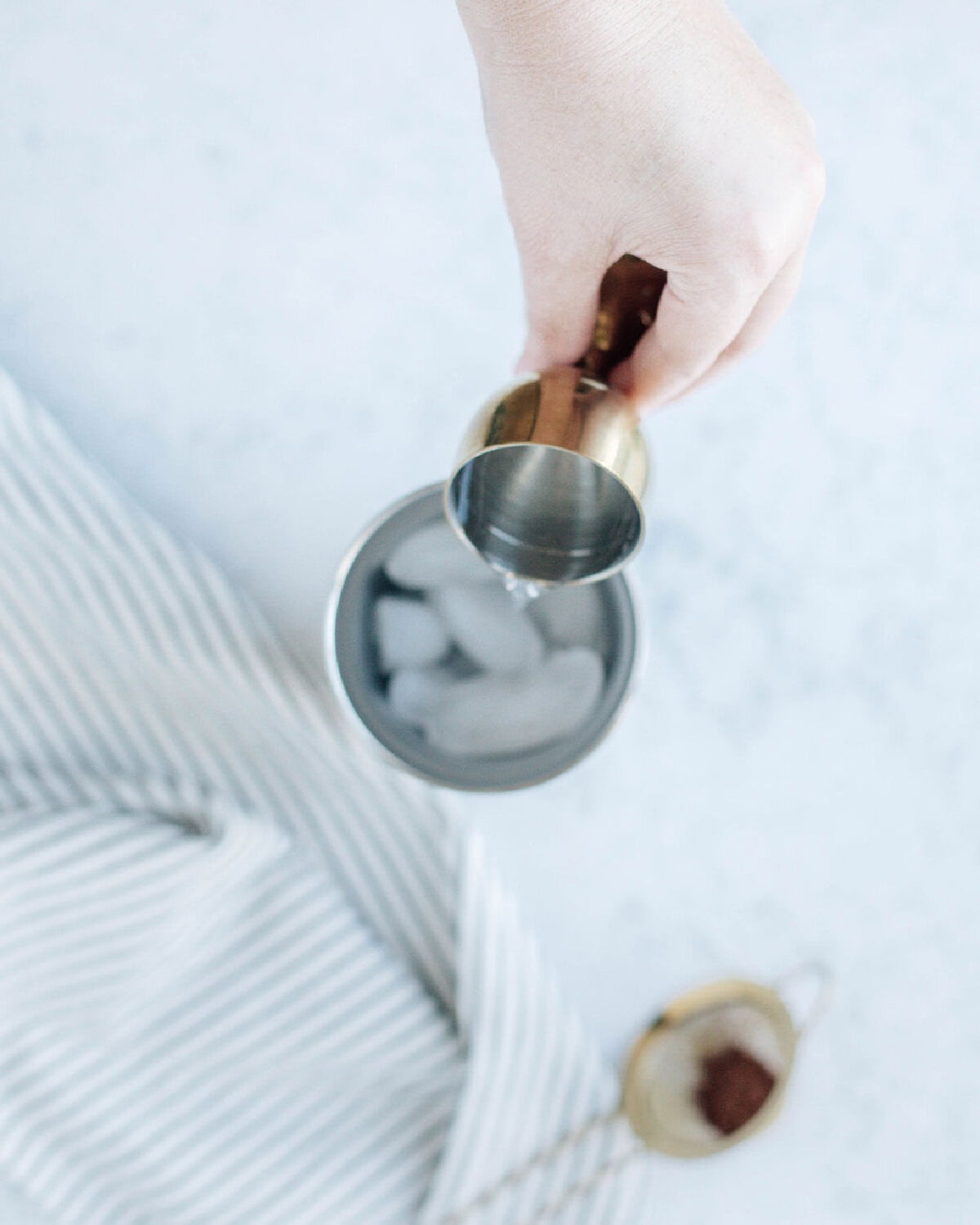 vanilla vodka poured over ice in a cocktail shaker.