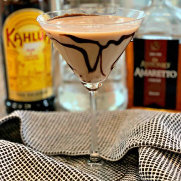 Tiramisu martini in a glass with a chocolate swirl.